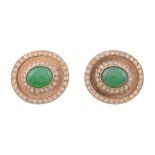 A pair of jadeite and diamond earrings, the oval shaped panels set with a...   A pair of jadeite and