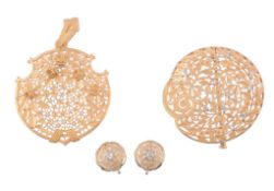 A gold coloured pendant, the circular shaped pendant with pierced foliate...   A gold coloured