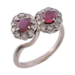 A ruby and diamond double cluster ring, the clusters each centred with an...   A ruby and diamond