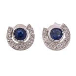 A pair of sapphire and diamond ear studs, the circular cut sapphire within a...   A pair of sapphire