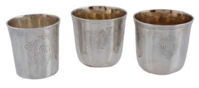 Three French silver beakers, comprising: a pair engraved with an armorial...   Three French silver