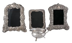 Three various silver mounted shaped rectangular embossed photograph frames   Three various silver