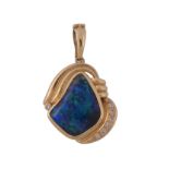 An opal and diamond pendant, the abstract shaped opal within a polished...   An opal and diamond
