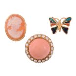 A coral and diamond earring, the central circular cabochon coral within a...   A coral and diamond