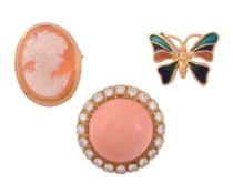 A coral and diamond earring, the central circular cabochon coral within a...   A coral and diamond