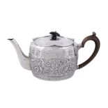 A late Victorian silver oval tea pot by William Comyns, London 1898   A late Victorian silver oval