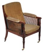 A late George III mahogany framed, caned and upholstered library chair   A late George III