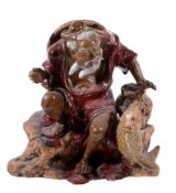 A Chinese stoneware figure of a fisherman, glazed in red and brown, 23.5cm high   A Chinese