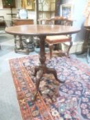 A George III mahogany tripod table, circa 1780, 72cm high, the top 70cm diameter   A George III