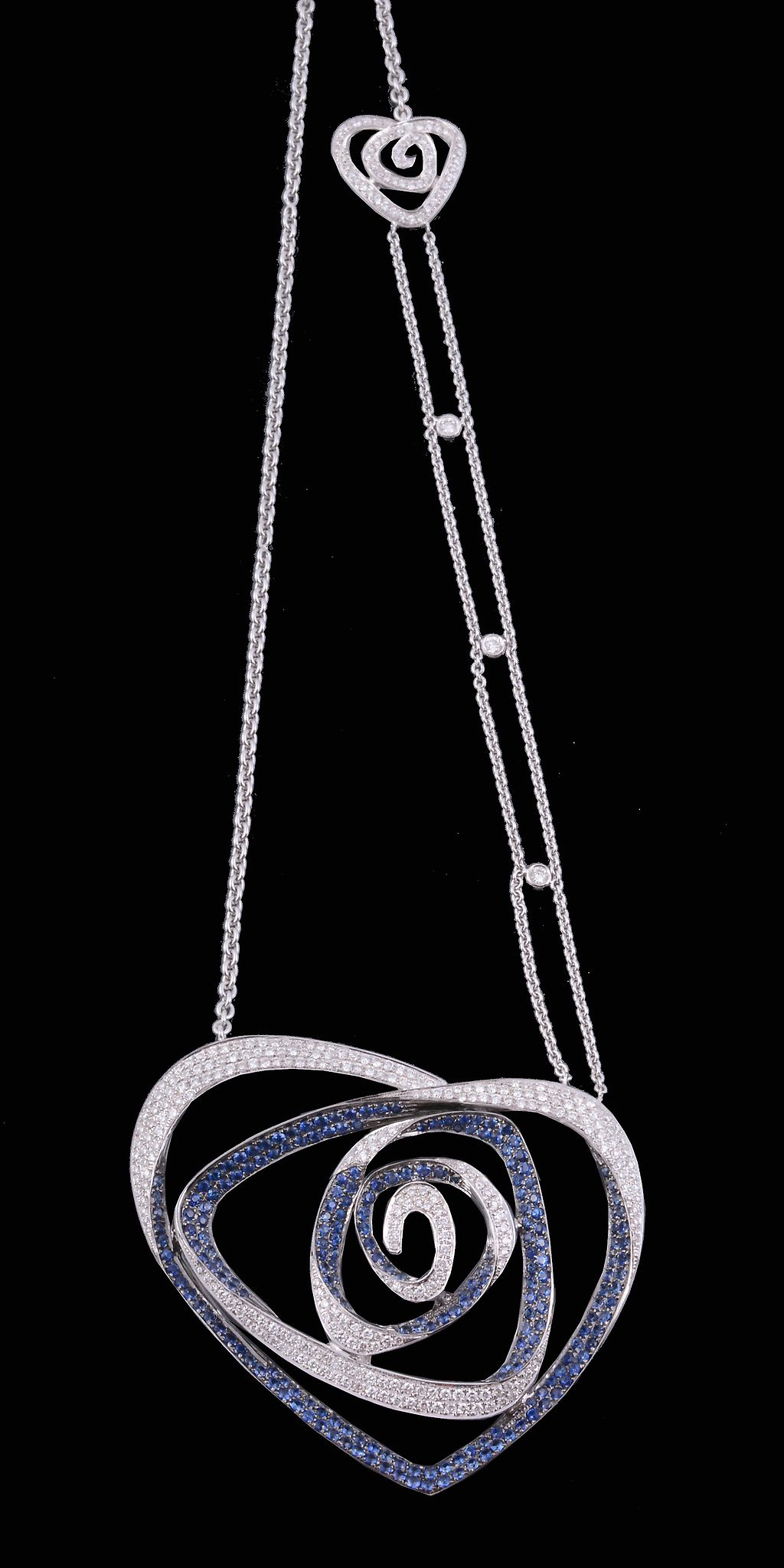 A sapphire and diamond pendant, the abstract heart shaped rose pendant set...   A sapphire and