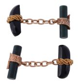A pair of hardstone cufflinks, each cufflink with a shaped polished onyx...   A pair of hardstone