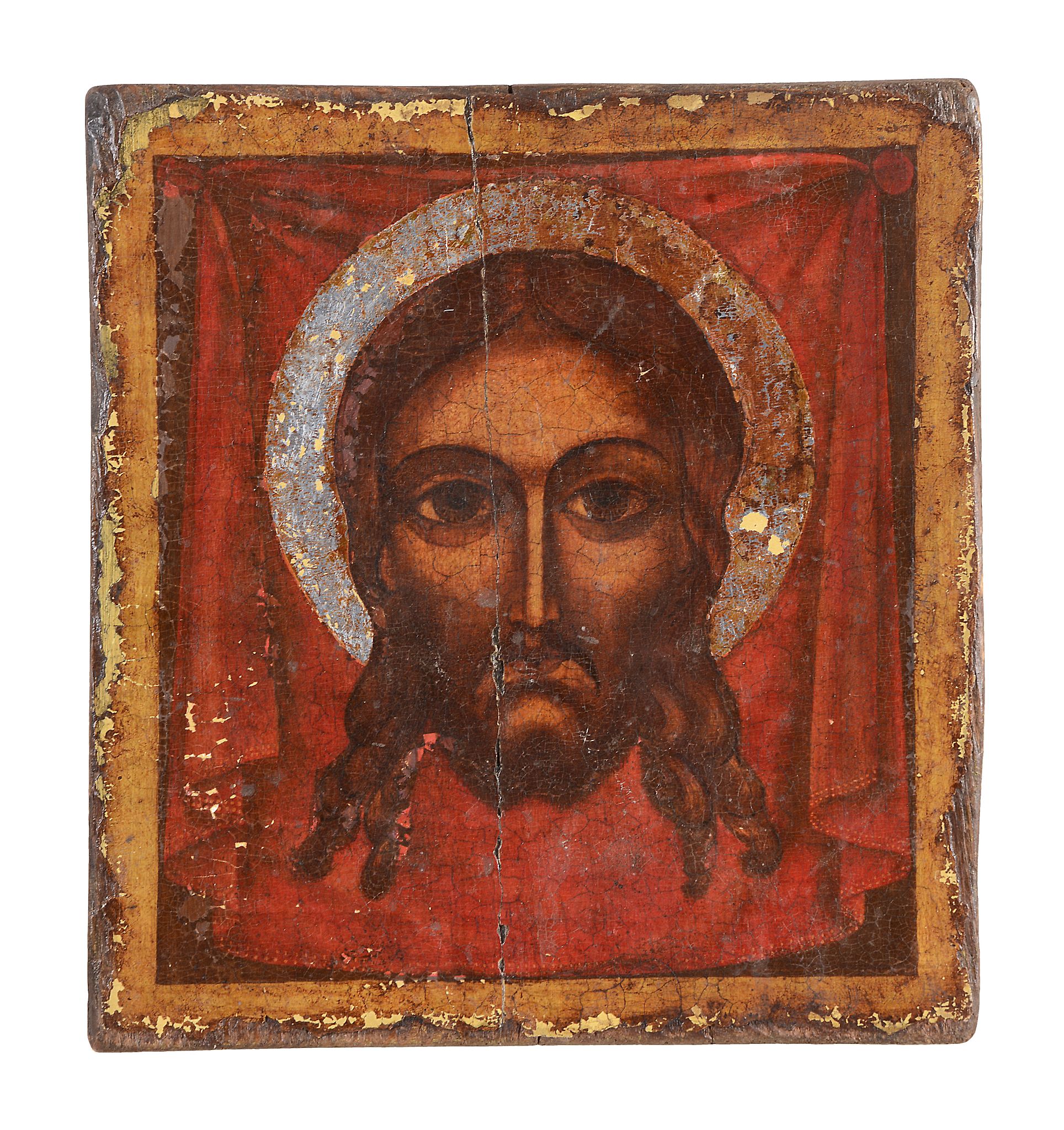 A polychrome painted and parcel silvered icon, the Holy Face, probably Greek   A polychrome