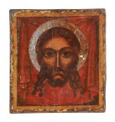 A polychrome painted and parcel silvered icon, the Holy Face, probably Greek   A polychrome