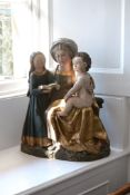 A German sculpted, polychrome painted and parcel gilt wood group of Saint...   A German sculpted,