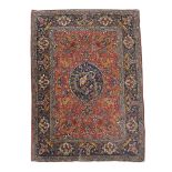 A Kashan rug, the central navy reserve decorated with a bird and its young   A Kashan rug,   the