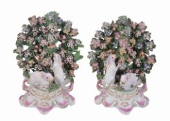 A pair of Derby porcelain bocage groups with white rabbits, circa 1765   A pair of Derby porcelain