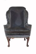 A George II mahogany and upholstered wing armchair , circa 1735   A George II  mahogany and
