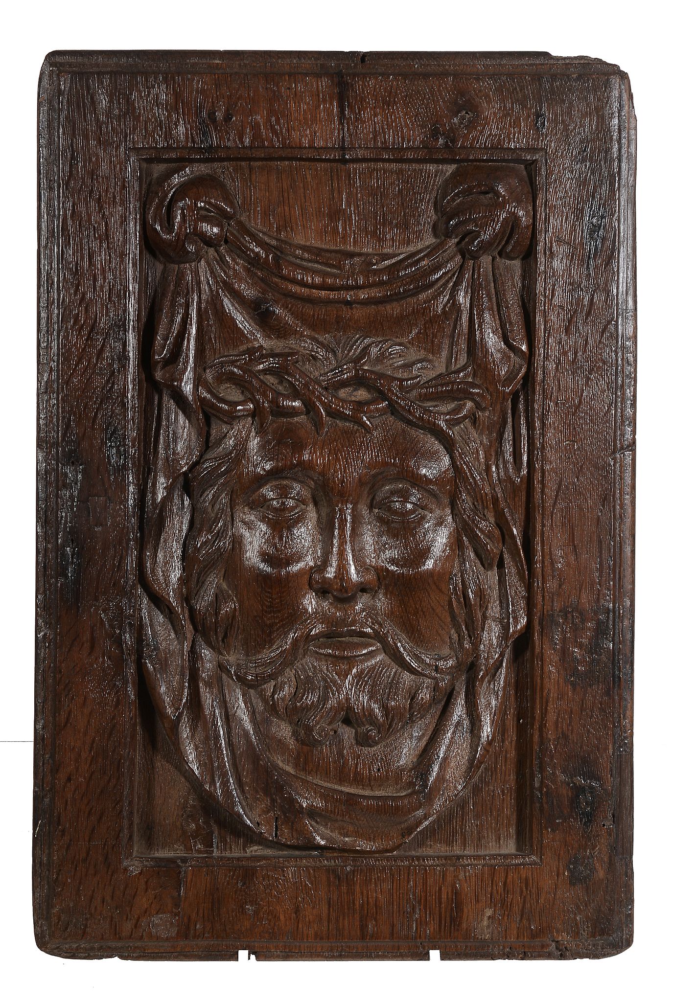 A recessed relief sculpted oak panel depicting the face of Christ, circa 1500 A recessed relief