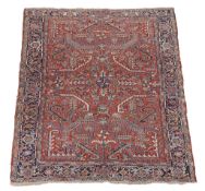 A Heriz carpet , the red field profusely decorated with geometric foliate...   A Heriz carpet  , the
