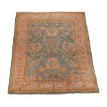 An Ushak carpet, the green field decorated with palmettes and flowerheads in...   An Ushak carpet,