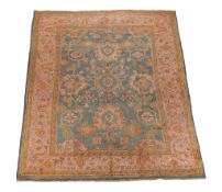An Ushak carpet, the green field decorated with palmettes and flowerheads in...   An Ushak carpet,