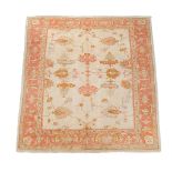 An Ushak carpet, decorated with stylised foliage and palmettes in orange and...   An Ushak carpet,