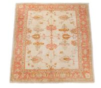 An Ushak carpet, decorated with stylised foliage and palmettes in orange and...   An Ushak carpet,