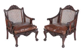 A pair of mahogany bergere library chairs in George II style, late 19th century   A pair of mahogany