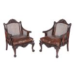 A pair of mahogany bergere library chairs in George II style, late 19th century   A pair of mahogany