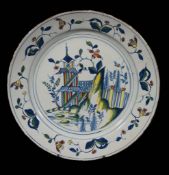 An English delft chinoiserie polychrome charger, probably Bristol or Wincanton   An English delft