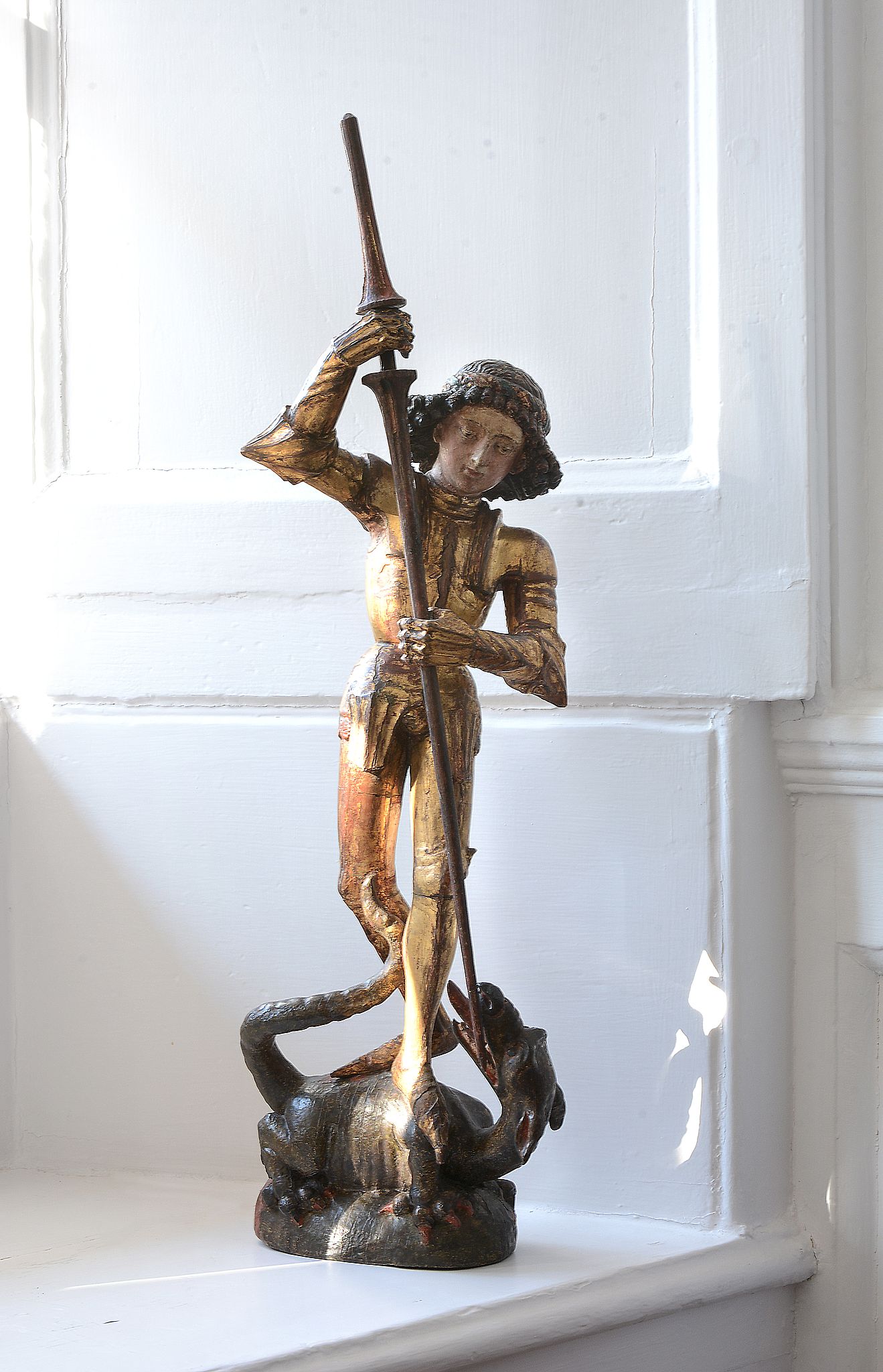A German sculpted, polychrome painted and gilt wood group of Saint George...   A German sculpted,