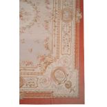 A woven carpet in Aubusson style, the central laurel medallion within the...   A woven carpet in