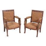 A pair of Empire parcel gilt armchairs , circa 1810, possibly Russian   A pair of Empire parcel gilt