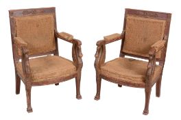 A pair of Empire parcel gilt armchairs , circa 1810, possibly Russian   A pair of Empire parcel gilt