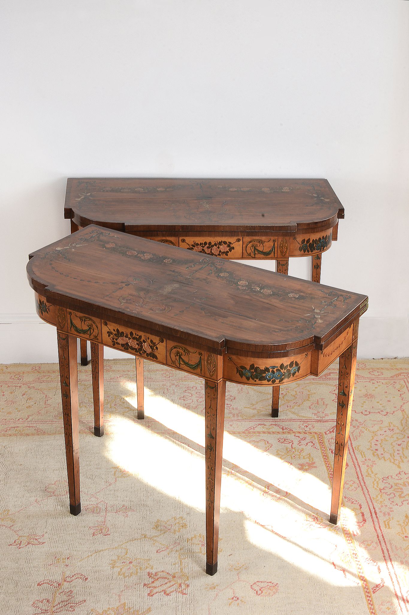 A pair of George III satinwood and painted folding card tables, circa 1790   A pair of George III