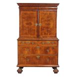 A Queen Anne walnut featherbanded cabinet on chest , circa 1710   A Queen Anne walnut