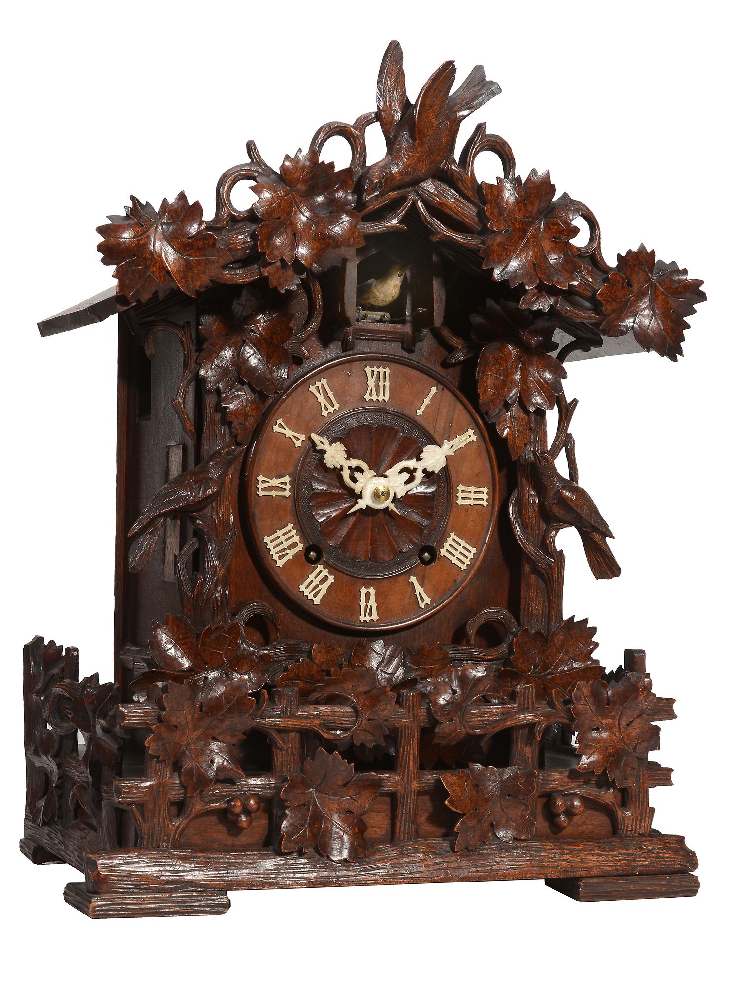 A Black Forest carved wood cuckoo table clock Attributed to Johann Baptist Beha   A Black Forest