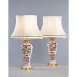A Pair of Small 18th Century Chinese Famille Rose Vases Now Mounted as Lamps each decorated with