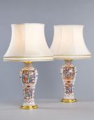 A Pair of Small 18th Century Chinese Famille Rose Vases Now Mounted as Lamps each decorated with