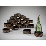 A Set of Eighteen Regency Japanned Papier Mâché Wine Coasters decorated with gilt floral sprays on a