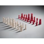 A 19th Century Ivory Chess Set with fine carved details in natural and red-stained ivory 12cm