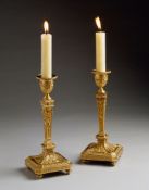A Pair of 18th Century Russian Ormolu Candlesticks decorated in high relief with neo-classical