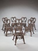 A Set of Eight 19th Century Cast Iron Garden Chairs in a rich patinated bronze colour, the heart-