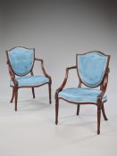 A Pair of George III Carved Mahogany Elbow Chairs attributed to Gillows the upholstered seats and