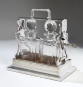 A Silver Plated Tantalus By Betjemann with twin cut glass decanters and stoppers, 30.5cm wide, 27.