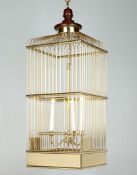 A Brass Bird Cage Lantern with a central three light candelabra, the top with a turned wooden finial