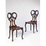 A Pair of George III Mahogany Hall Chairs in the Manner of Chippendale the pierced scroll backs