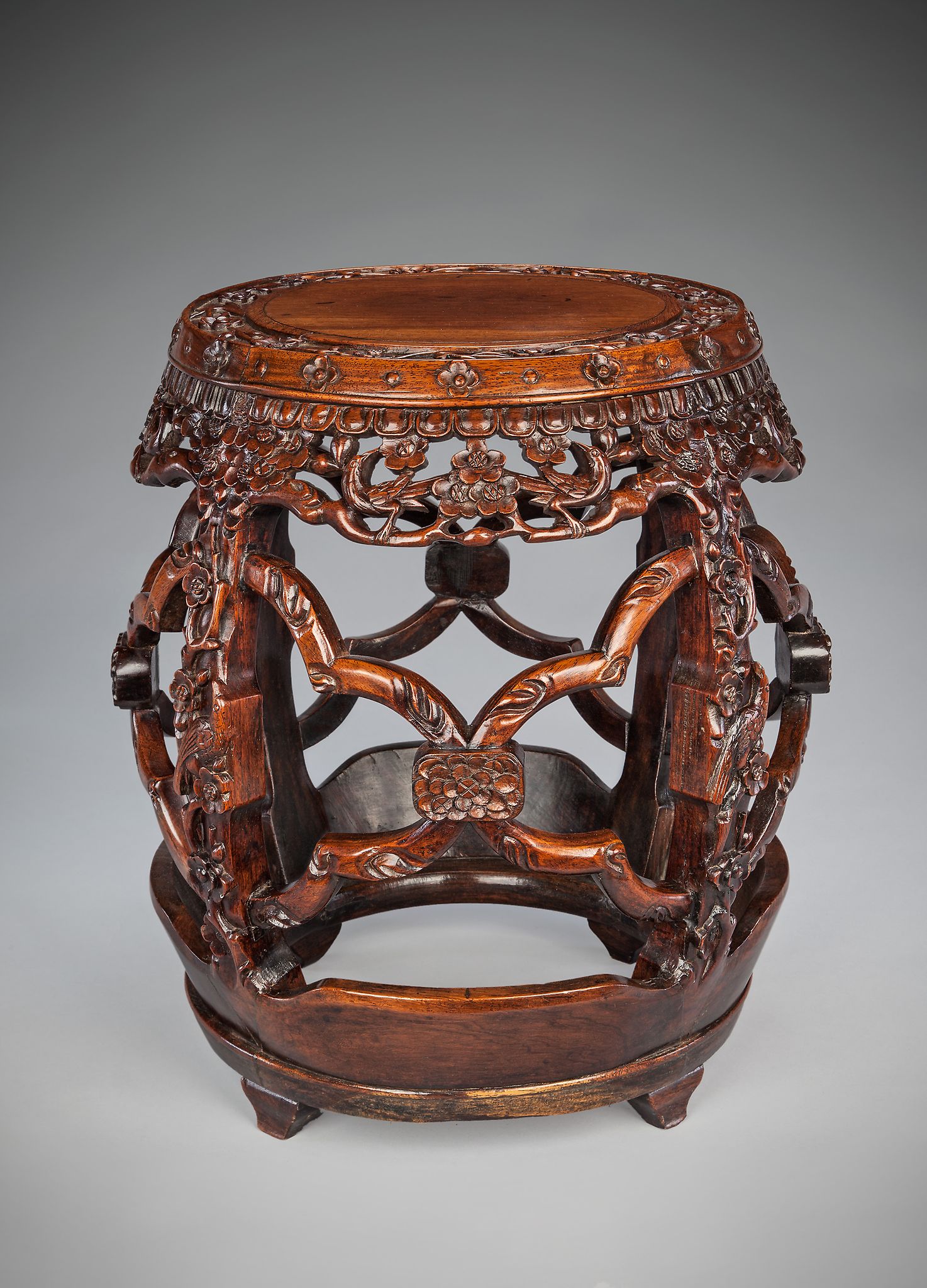 A 19th Century Carved Chinese Hardwood Seat of open-sided ºrrel' type with prunus, bird and flower-