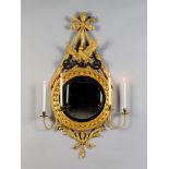 A Pair of Regency Giltwood Convex Girandoles each with a carved bow and ribbon suspending a