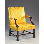 A 19th Century George III Style Carved Mahogany Library Armchair The scrolling arm supports headed